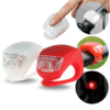 Silicone LED bike lights in white and red, mounted on handlebars and seatpost, shown in day and night use.