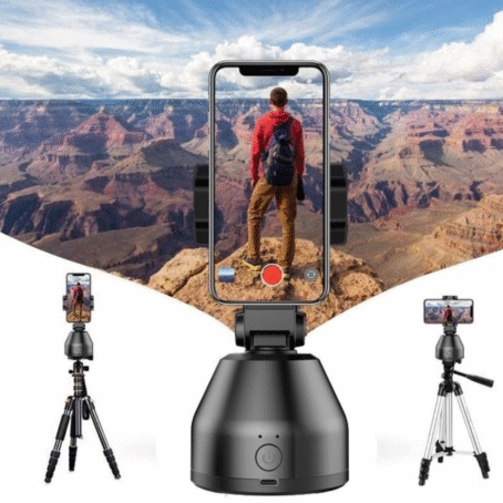 Automatic phone holder with tracking function, mounted on a tripod, recording a tourist standing on the edge of a canyon with a panoramic mountain view.
