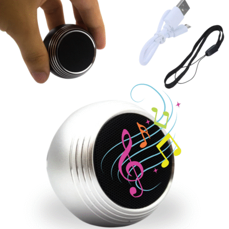 A mini portable Bluetooth speaker, shown in silver and held in hand for scale, with USB charging cable, carrying lanyard, and colorful music notes. Ideal for wireless music on the go, offering compact size and easy portability.