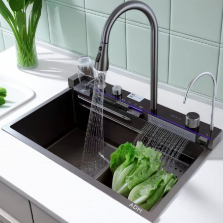 ADM multifunctional kitchen sink with a touch panel and modern faucet, shown in use for washing vegetables and glasses. The sink features separate water stream modes and a stylish design.